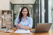 © itchaznong - Financier a asian woman works, uses a mobile phone, makes a report to a finance company. Accounting and financial concept