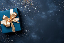 Elegant Blue Present Box With Golden Bow On A Dark Blue Background, Copy Space. Gift Box, Top View. 