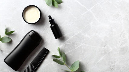 Wall Mural - Mens hair care beauty products on stone table. Jar of cream, shampoo bottle, hair comb, essential oil with eucalyptus leaves. Natural organic cosmetics packaging design, branding. Top view. Flat lay.