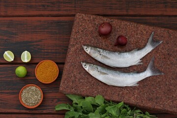 Wall Mural - Sea fish mullet, Buri, Loban, on a wooden table, top view, background image, for presentations