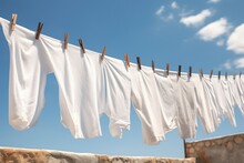White Linen Drying On A Clothesline