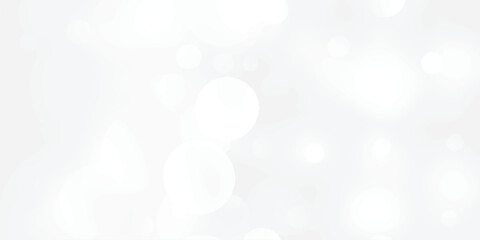 Abstract silver bokeh background with white light at center. The bokeh on the white background blurred the natural gray and white. Bokeh colorful glows sparkle.