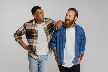 two happy men smiling and posing at camera while standing isolated