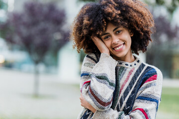 Wall Mural - young African American woman portrait in city of Latin America, Hispanic and caribbean people with afro hair on winter and cold weather