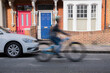 © Westend61 - Blurred motion of delivery person riding bicycle on road
