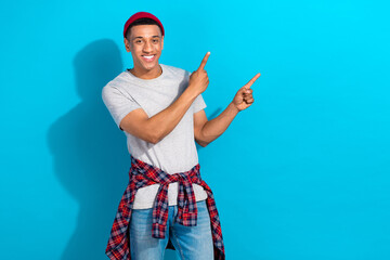 Sticker - Photo of positive sweet guy dressed grey t-shirt pointing two fingers empty space isolated blue color background