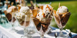 © Anneleven - Ice cream desserts buffet table, event food catering for wedding, party and holiday celebration, ice creams and flowers decor in a floral countryside garden, generative ai