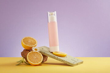 Canvas Print - Pink bottle mockup for cosmetic, half of lemon and stone displayed on purple background. Lemon is high in vitamin c which boosts collagen and improves hair growth by stimulating hair follicles