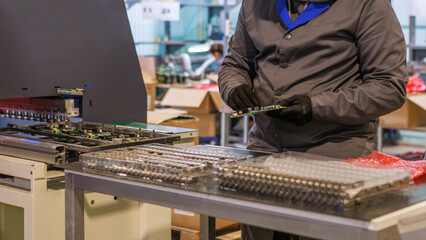 Engineer checking a TV board with chips and transistors.