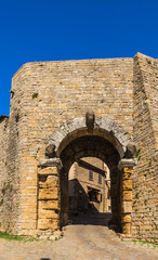 Wall Mural - Volterra, Italy. Arched gates (Porta all'Arco, IV-III century BC - I century BC). Three stone heads presumably depict Etruscan or Roman gods