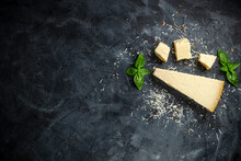 Hard Cheese On Black Background. Parmesan. Top View. Free Space For Your Text.