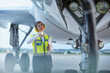 © KOTO - Ground crew worker under airplane with flashlight on airport tarmac