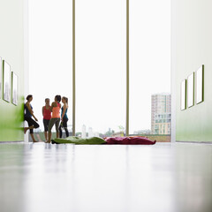 Wall Mural - Women talking at window in exercise class gym studio