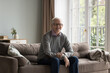© fizkes - Satisfied smiling senior man wear eyeglasses staring at camera. Portrait of happy, healthy and wellbeing pensioner, single mature male resting alone seated on couch posing for cam. Carefree retirement