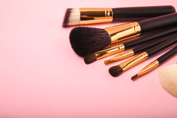 Wall Mural - Cosmetic makeup brush on a pink background. Cosmetic product for make-up. Creative and beauty fashion concept. Fashion. Collection of cosmetic makeup brushes, top view, banner.Place for text. MOCAP.