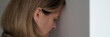 © H_Ko - Tired depressed woman banging her head against wall. Hopeless situations concept