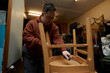 © Connect Images - Worker with Down syndrome fixing chair