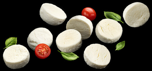 Wall Mural - Falling mozzarella cheese slices on black background