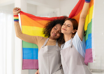 Wall Mural - Multiracial woman and girlfriend holding rainbow flag happy hug and smiling. Multiethnic lgbt people, gay women bonding being couple family. Homosexual, lesbian, human rights, LGBTQ pride concept.
