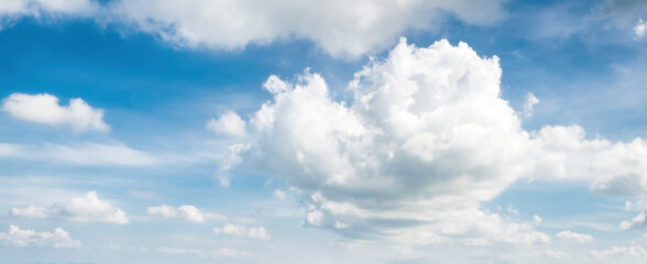 Wall Mural - White fluffy clouds in blue sky