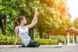 Young Indian woman wearing sports bra yoga teacher poses stretching exercises in garden. Healthy concept