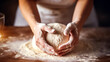 Woman hands that knead dough, bright light, professional color grading, soft shadows