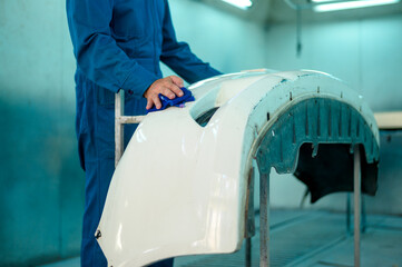 Wall Mural - close up Caucasian man hand cleaning car part before painting  in paint shop