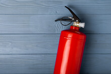 Fire Extinguisher On A Blue Textural Background. Fire Protection, Home Fire Extinguisher. Home Security Concept. Place For Text. Copy Space.banner