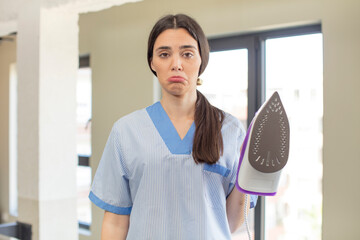 Wall Mural - pretty young model feeling sad and whiney with an unhappy look and crying. housekeeper and laundry concept