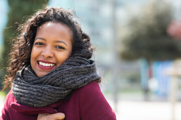 Beautiful young black woman with winter scarf outside