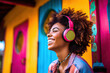 © ADDICTIVE STOCK - Generative AI illustration of happy african american woman with afro hair in colorful outfit and headphones near colorful house enjoying sun