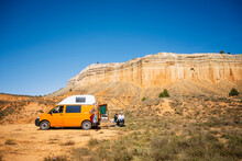 Yellow Camper Van With People At Canyon Cliff