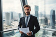 © ADDICTIVE STOCK - Generative AI image of confident bearded businessman with papers looking at camera while standing in lift with glass walls against blurred cityscape