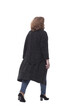 © ASDF - rear view. mature woman in a fashionable cardigan walking away
