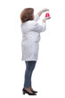© ASDF - side view. the doctor is looking at a flask of red liquid
