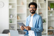 © Prostock-studio - Portrait Of Handsome Indian Male Freelancer With Digital Tablet In Hands