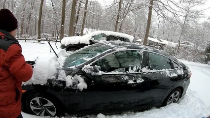 Wall Mural - time-lapse of woman cleaning the car in the driveway after the snow storm in February