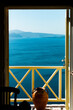 open door to the balcony view of the santorini caldera view aegean sea greece