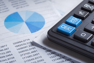 calculator and financial charts. Investment and capital accumulation concept