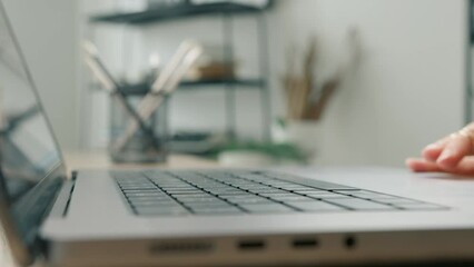 Close up on female hands of professional entrepreneur opening laptop computer and starting working in business office. Woman working with statistic data or research online on bright office background