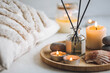canvas print picture - Cozy corner for home meditation and relaxation. Aroma diffuser, burning candles, stones for comfort, pleasure, aromatherapy. Decor for apartment, house, indoors design