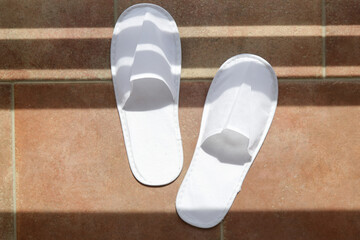 Wall Mural - Blank white hotel slippers. Towelling disposable spa guest shoes. Top view