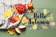 Banner with text HELLO AUTUMN, fallen leaves, rowan berries and apples