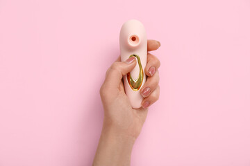 Woman with vibrator on pink background