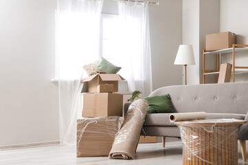 Wall Mural - Sofa with rolled carpet and cardboard boxes in living room on moving day