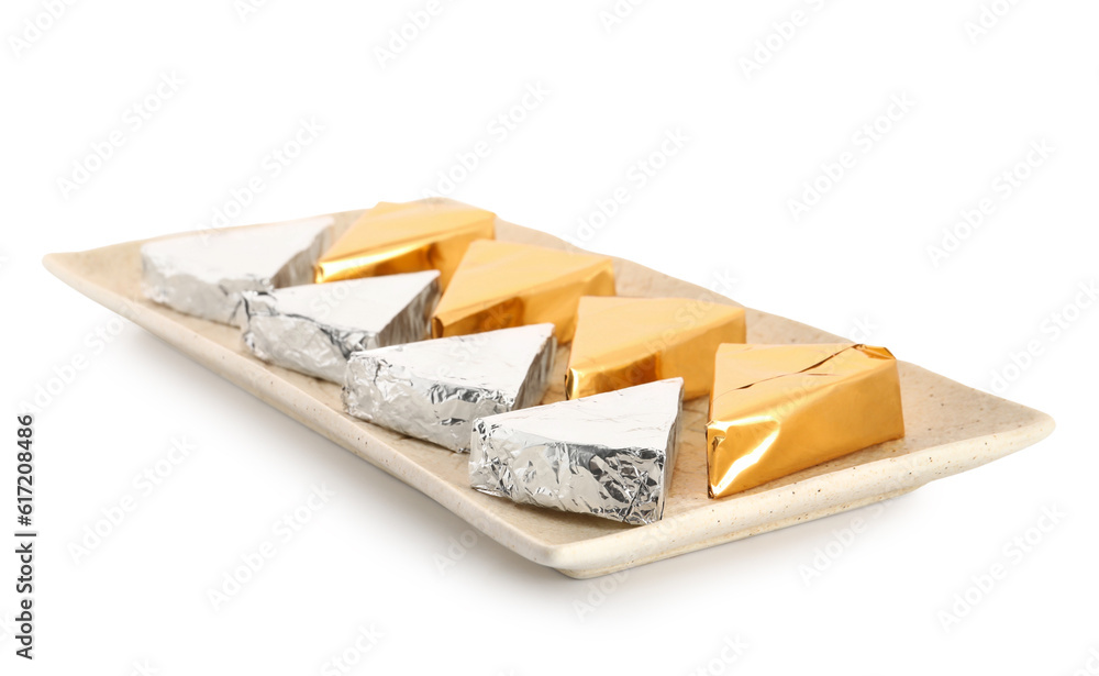 Plate with triangles of tasty processed cheese on white background