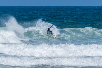 Surfer riding waves in Furadouro Beach