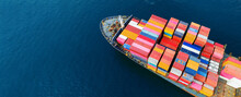Aerial Top View Cargo Ship Carrying Container And Running For Export Goods From Cargo Yard Port To Other Ocean Concept Freight Shipping Ship .