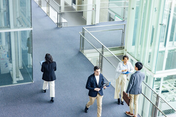 Poster - Multinational business group talking in lobby. Global business. High angle view.