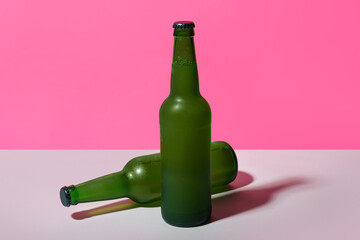 Bottles of cold beer on color background